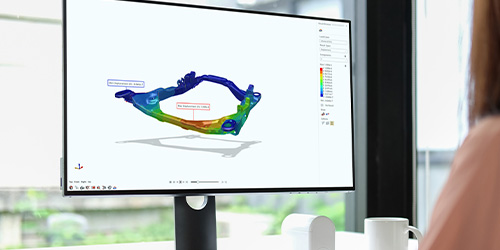 An engineer reviewing simulation results of a subframe model with web native 3D visualization in Simulation Cloud Suite.